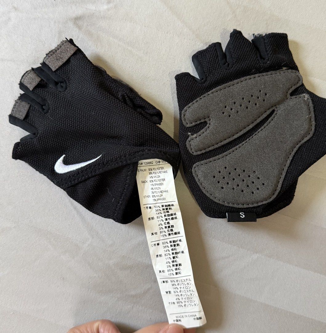 Nike Gym Gloves (Category: Gloves) located in Paranaque City. Submitted by declutternsell.729 (Listing ID 1465708337, Image 2). Description: - Brand: Nike - Item: Fingerless Gloves - Color: Black with white swoosh - Size: Small - Palms: Grey padded with ventilation holes for grip and comfort - Material: Polyester, polyurethane, nylon, and spandex blend - Ideal for: Gym sessions, weightlifting, and cycling SIZE: small.