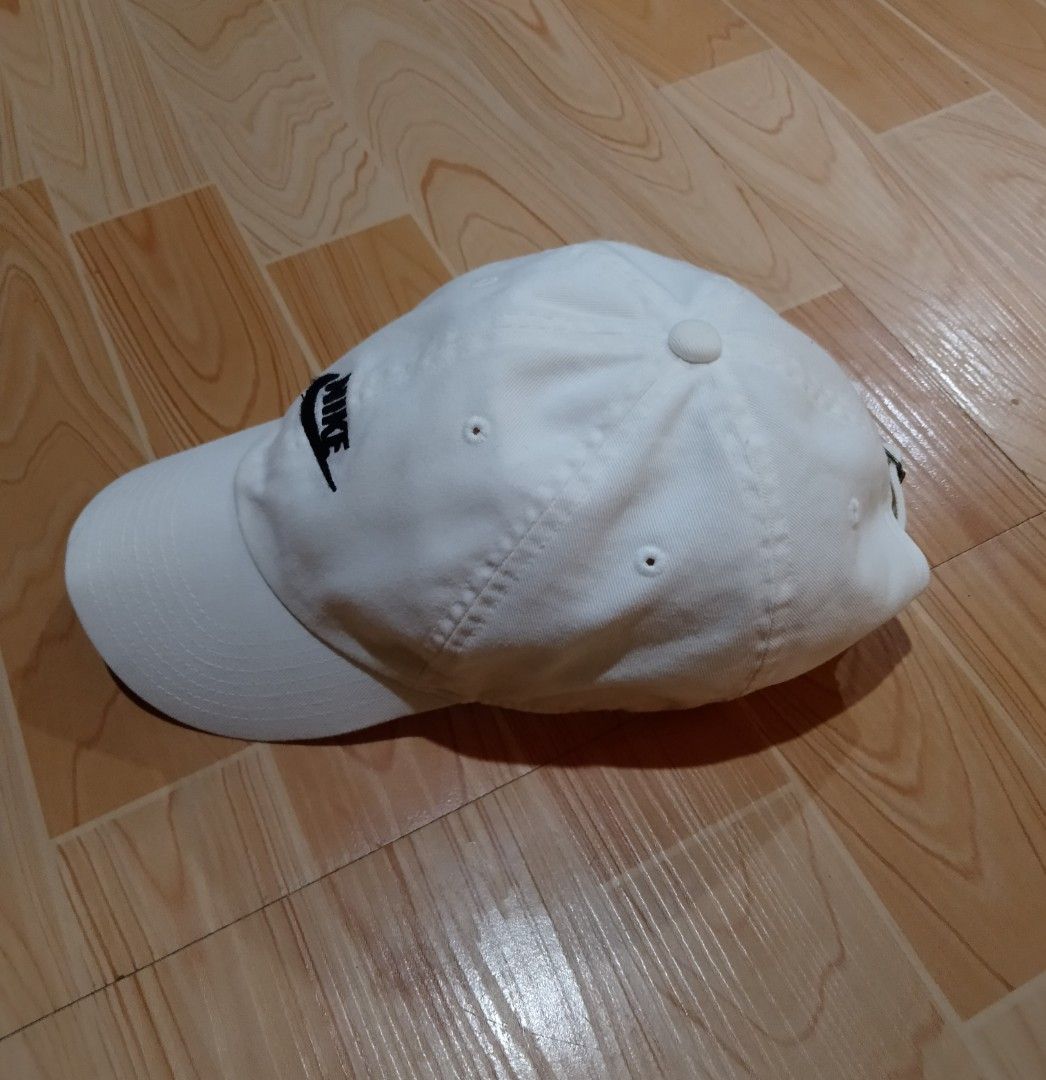 Nike Heritage86 White Cap (Category: Caps & Hats) located in San Jose del Monte. Submitted by azetor (Listing ID 1465594396, Image 2). Description: - Brand: Nike Heritage86 - Color: Crisp white with black embroidered logo - Material: 100% cotton body (65% polyester, 35% cotton lining) - Fit: Classic fit with adjustable metal buckle strap - Condition: Clean and ready to wear - Ideal for: Daily casual outings and streetwear - great condition .