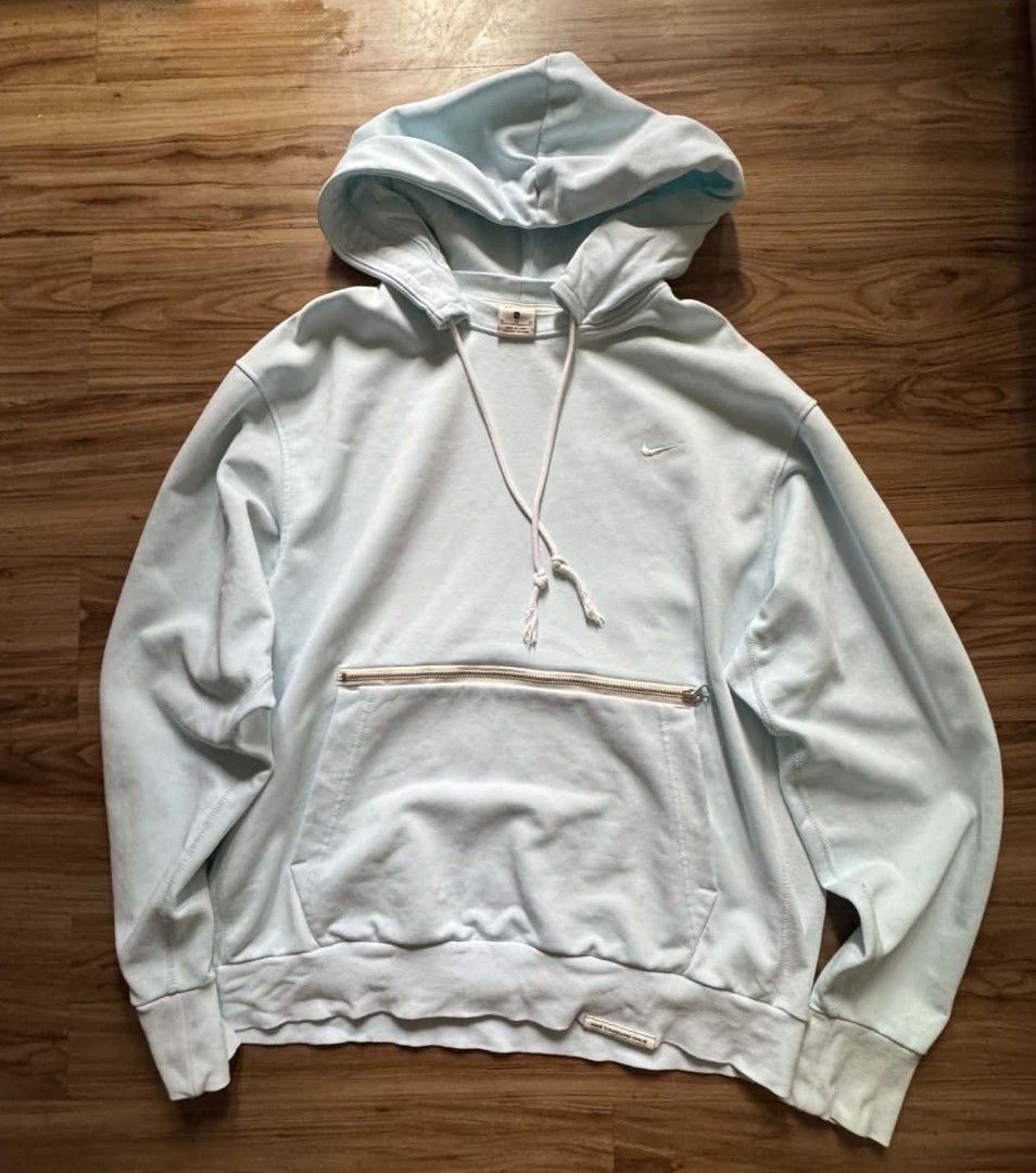 Nike Light Blue Hoodie with Front Zip Pocket (Category: Coats, Jackets and Outerwear) located in Caloocan City. Submitted by jpygoodies (Listing ID 1465721142, Image 1). Description: - Brand: Nike - Color: Light blue - Size: Small - Design: Embroidered swoosh logo on left chest - Pockets: Front kangaroo pocket with top zippered compartment - Details: Matching white drawstrings with knotted ends, ribbed cuffs and hem - Fit: Relaxed fit style - Mat