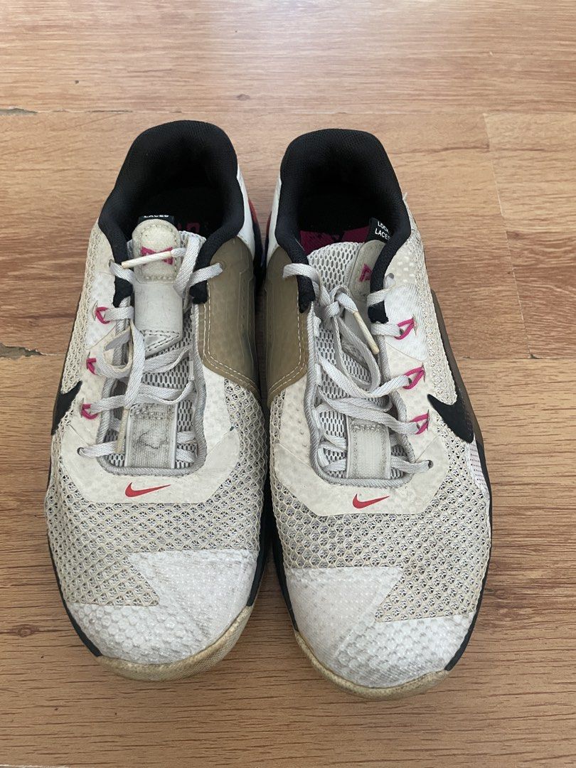 Nike Metcon 7 Training Shoes Size US 8 (Category: Sneakers) located in Mandaluyong City. Submitted by zaiampiloquio (Listing ID 1465605606, Image 1). Description: - Brand/Model: Nike Metcon 7 (Style Code: DJ8656-018) - Colorway: White, Black, and Tan - Size: Women's US 8 / UK 5.5 / EUR 39 / CM 25 - Condition: Shows visible signs of wear on mesh uppers, laces, and rubber outsoles - Features: Solid tread remaining and stable blue Hyperlift heel pla