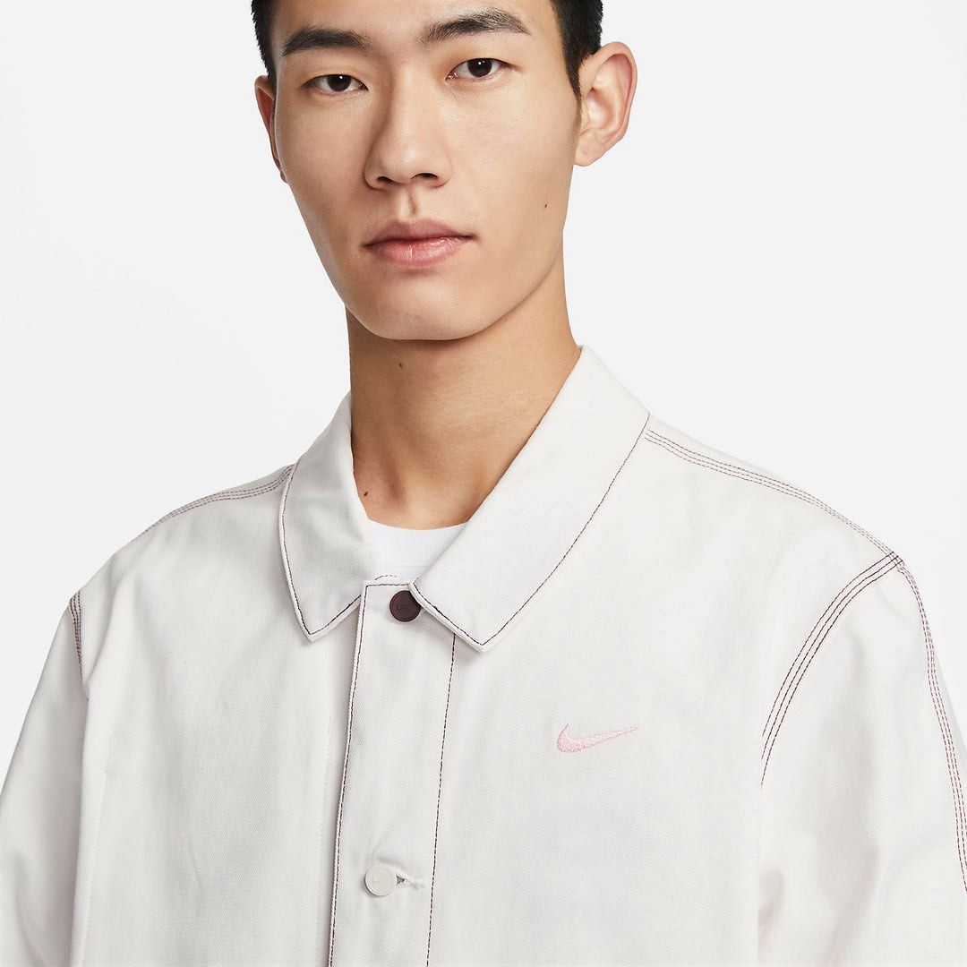 Nike Sportswear Lapel Work Jacket (Category: Coats, Jackets and Outerwear) located in Manila. Submitted by loydgani (Listing ID 1465699009, Image 1). Description: - Brand: Nike (Sportswear Lapel Work Jacket) Dimes: Length 31 Width 22 Sleeve Length 33 Sleeve hemp 6 - Color: White Grey Size (S) - Details: Small embroidered pink Nike swoosh on the chest, regular collar, distinctive top button, and front button closure - Pockets: Two lower front patc