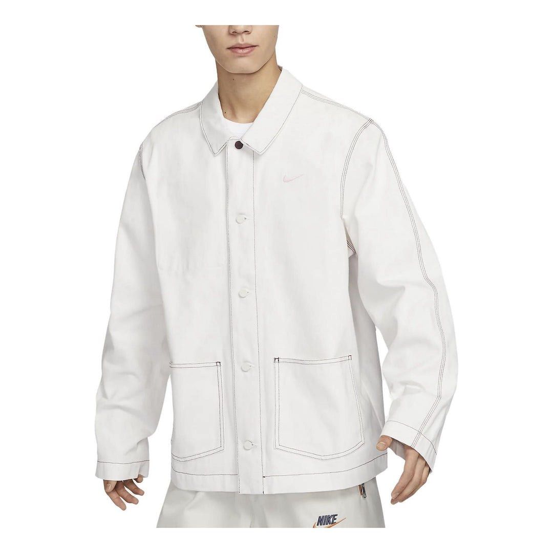 Nike Sportswear Lapel Work Jacket (Category: Coats, Jackets and Outerwear) located in Manila. Submitted by loydgani (Listing ID 1465699009, Image 2). Description: - Brand: Nike (Sportswear Lapel Work Jacket) Dimes: Length 31 Width 22 Sleeve Length 33 Sleeve hemp 6 - Color: White Grey Size (S) - Details: Small embroidered pink Nike swoosh on the chest, regular collar, distinctive top button, and front button closure - Pockets: Two lower front patc