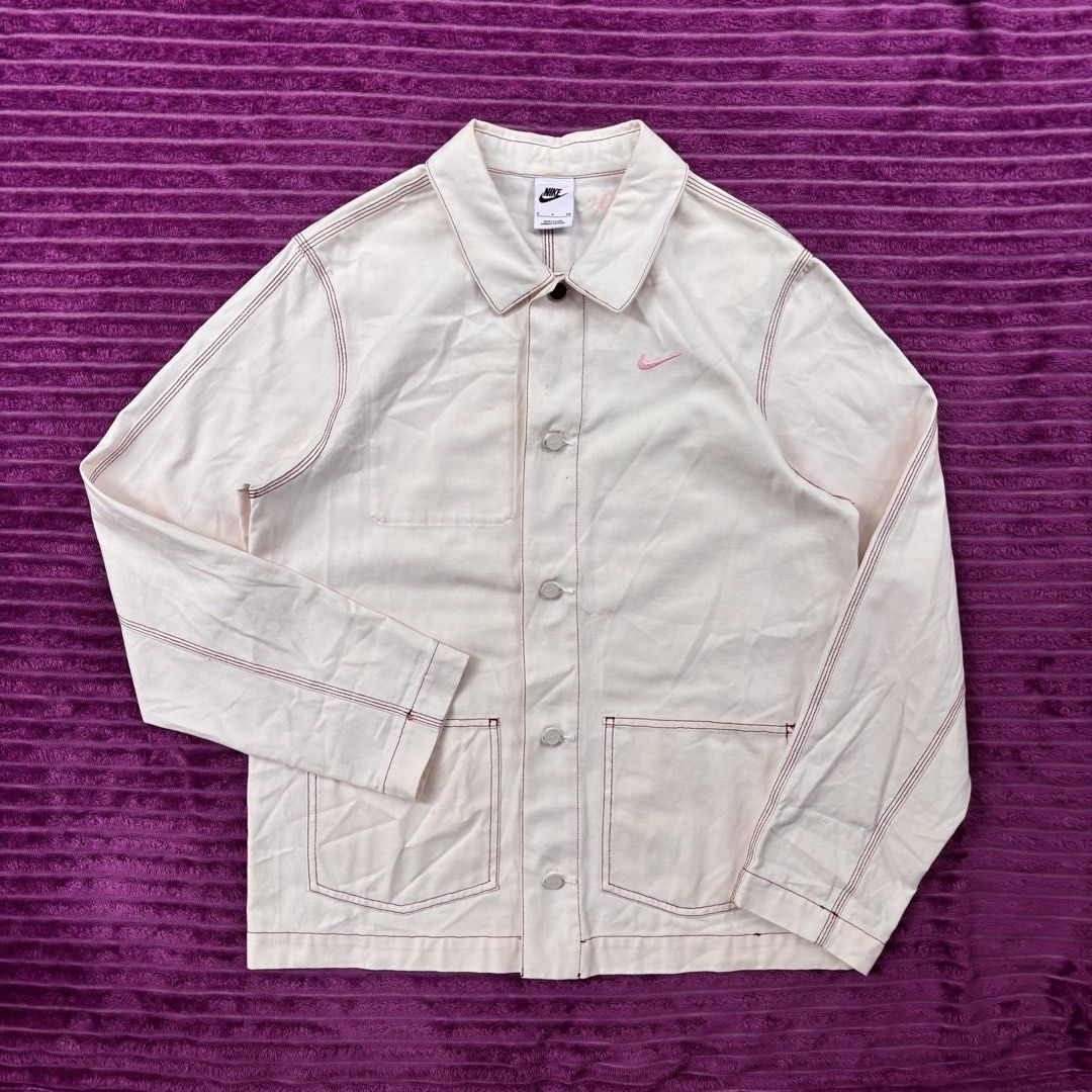 Nike Sportswear Lapel Work Jacket (Category: Coats, Jackets and Outerwear) located in Manila. Submitted by loydgani (Listing ID 1465699009, Image 3). Description: - Brand: Nike (Sportswear Lapel Work Jacket) Dimes: Length 31 Width 22 Sleeve Length 33 Sleeve hemp 6 - Color: White Grey Size (S) - Details: Small embroidered pink Nike swoosh on the chest, regular collar, distinctive top button, and front button closure - Pockets: Two lower front patc