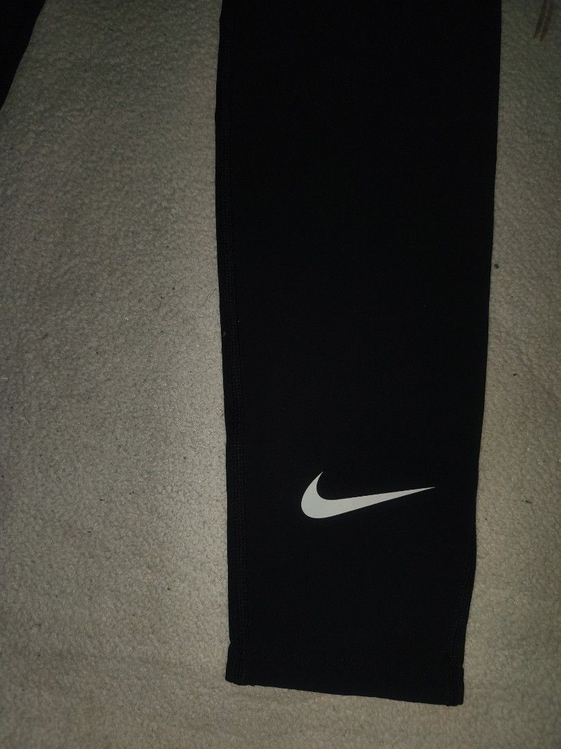 Nike Pro Black Compression Tights Leggings (Category: Activewear) located in Cagayan de Oro. Submitted by elijah350below (Listing ID 1465681554, Image 3). Description: - Brand: Nike Pro - Color: Classic Black - Size: Standard fit - Features: Elastic logo waistband, white swoosh on lower left leg - Material: Breathable, stretchy athletic fabric - Design: Paneled construction for maximum mobility and active movement - Condition: Excellent / Pre-lov