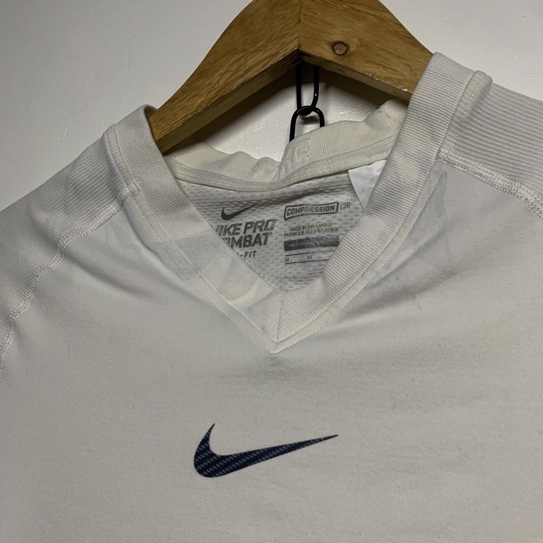 Nike Pro Combat Dri-Fit White Compression Shirt Size M (Category: Activewear) located in Manila. Submitted by grapplers.gallery (Listing ID 1465743243, Image 2). Description: - Brand: Nike Pro Combat - Size: M - Color: White - Fit: Compression / Short sleeves / V-neck - Technology: Dri-Fit moisture-wicking - Design: Textured front Swoosh and Pro Combat hem patch - Ventilation: Seamless knit with back and side zones - Origin: Made in Sri Lanka - C