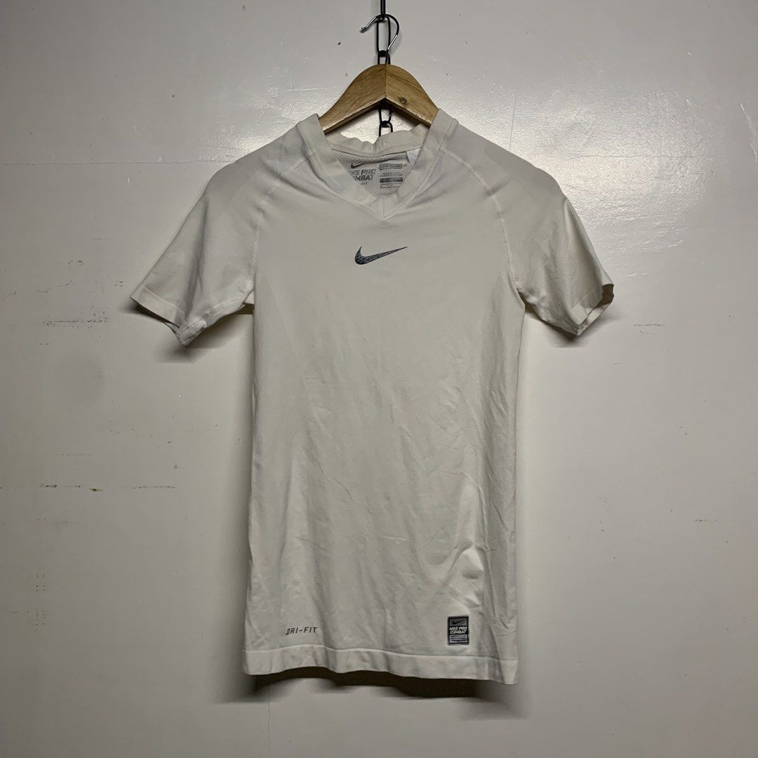 Nike Pro Combat Dri-Fit White Compression Shirt Size M (Category: Activewear) located in Manila. Submitted by grapplers.gallery (Listing ID 1465743243, Image 1). Description: - Brand: Nike Pro Combat - Size: M - Color: White - Fit: Compression / Short sleeves / V-neck - Technology: Dri-Fit moisture-wicking - Design: Textured front Swoosh and Pro Combat hem patch - Ventilation: Seamless knit with back and side zones - Origin: Made in Sri Lanka - C