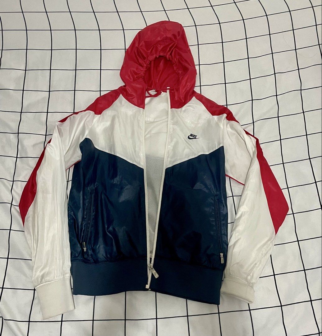 Nike Red White Blue Windbreaker Jacket (Category: Coats, Jackets and Outerwear) located in Tanauan. Submitted by elle0908 (Listing ID 1465597677, Image 1). Description: - Classic Nike tri-color block design - Full zip closure with dual front pockets - Lightweight mesh interior lining for breathability SF: Shoulder by buyer. RFS: Closet decluttering, need to make space..