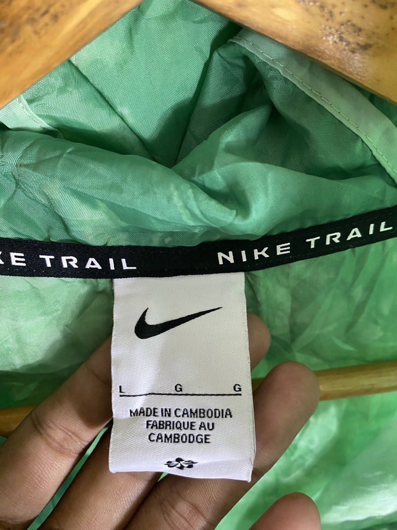 Nike Trail Green Windbreaker Jacket Size L (Category: Coats, Jackets and Outerwear) located in Manila. Submitted by carbertjakosalem (Listing ID 1465754579, Image 3). Description: - Brand: Nike Trail - Item: Lightweight hooded windbreaker jacket - Color: Green - Size: Large (tag attached) - Features: Full zip, packs down into its own built-in pouch - Ideal for: Running, hiking, and outdoor activities - Origin: Made in Cambodia - Condition: Brand 