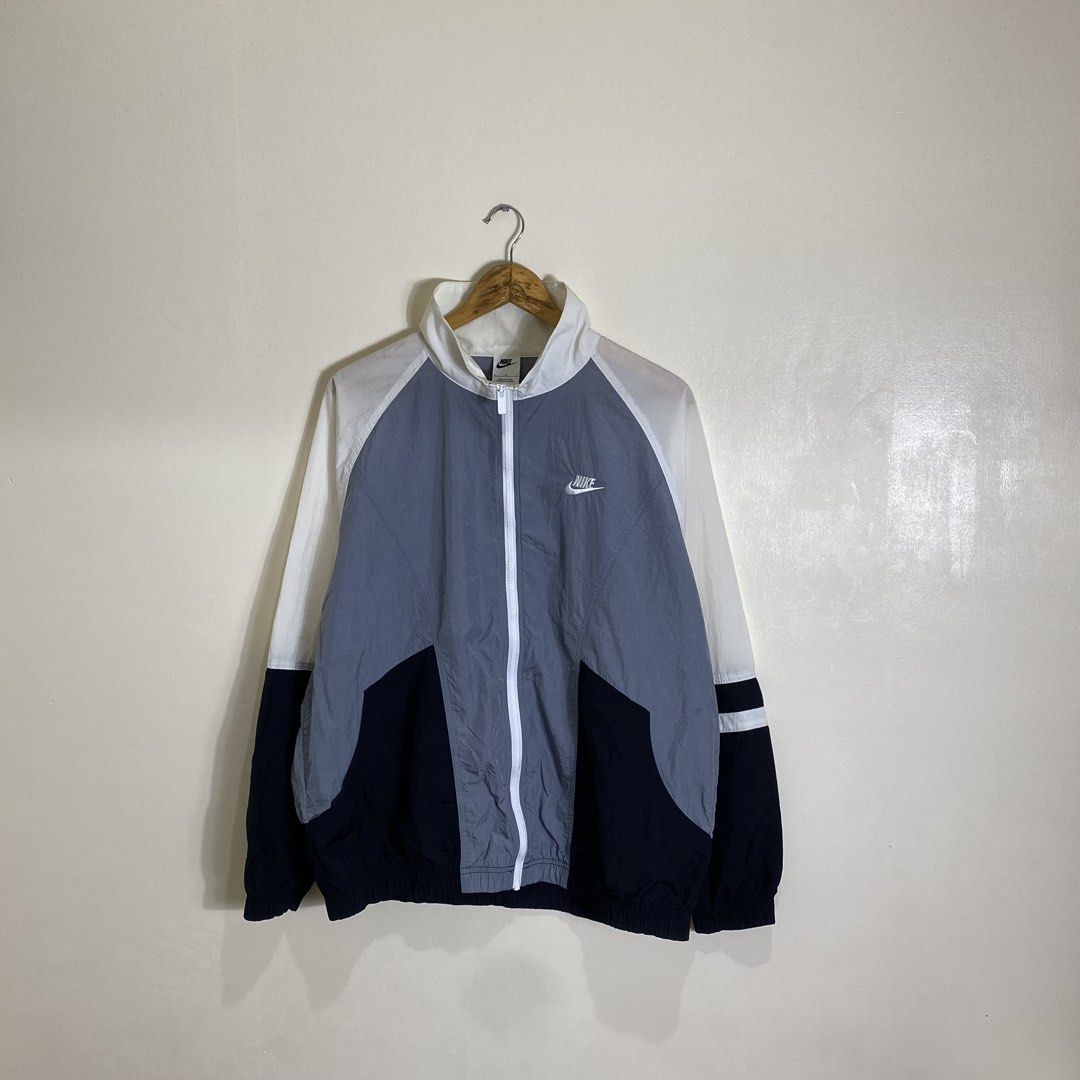 Nike Windbreaker Jacket White Grey Black Size L (Category: Coats, Jackets and Outerwear) located in Cebu City. Submitted by theloose.thread (Listing ID 1465754181, Image 1). Description: - Brand: Nike - Style: Full-zip colorblock windbreaker (White, Grey, Black) - Size: Large (Made in China) - Details: Large Nike back graphic, embroidered swoosh on chest, high collar - Condition: Clean, lightweight material perfect for breezy weather.