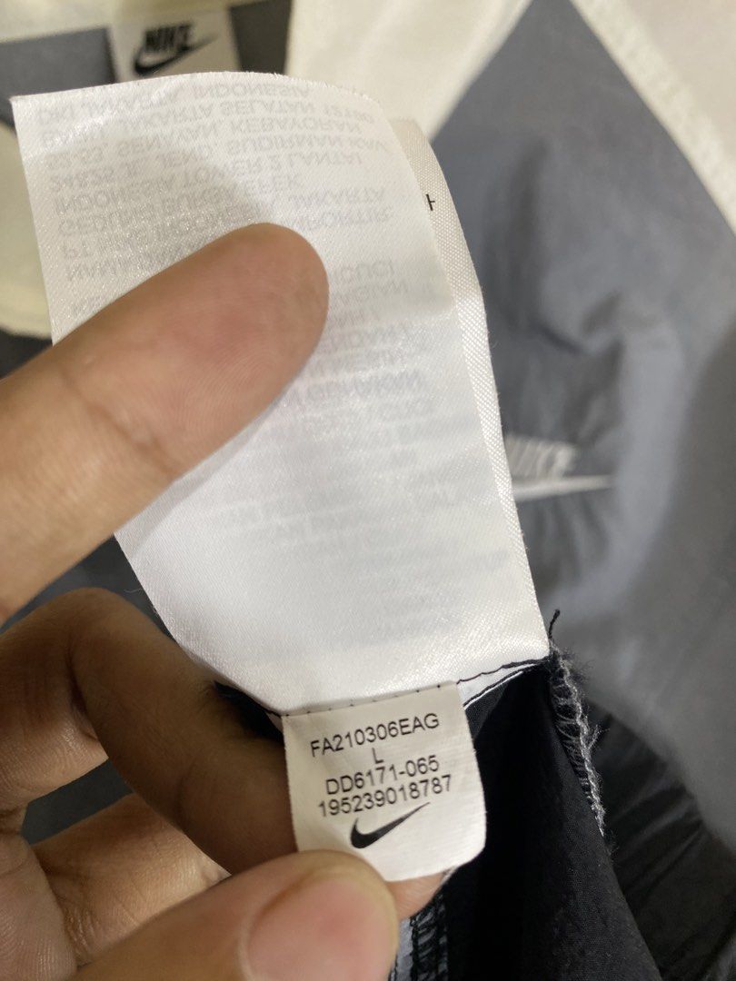 Nike Windbreaker Jacket White Grey Black Size L (Category: Coats, Jackets and Outerwear) located in Cebu City. Submitted by theloose.thread (Listing ID 1465754181, Image 3). Description: - Brand: Nike - Style: Full-zip colorblock windbreaker (White, Grey, Black) - Size: Large (Made in China) - Details: Large Nike back graphic, embroidered swoosh on chest, high collar - Condition: Clean, lightweight material perfect for breezy weather.