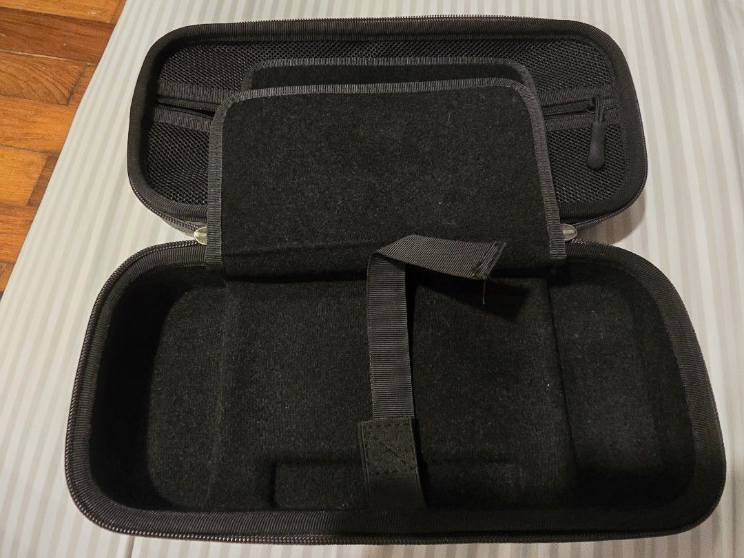 Nintendo Switch 1 V1 Carry Case (Category: Cases & Covers) located in Baguio. Submitted by joccsells (Listing ID 1465619639, Image 2). Description: for Nintendo Switch V1 - Color: Dark grey textured fabric - Hard shell exterior with soft black interior lining to prevent scratches - Built-in divider flap with multiple elastic game card slots - Mesh zipper pocket inside the top lid for cables and small accessories - Secure dual zipper closure for s