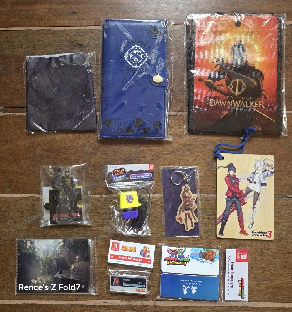 Nintendo Switch and Playstation various preorder items (Category: In-Game Products) located in Manila. Submitted by gamengrind (Listing ID 1465629625, Image 1). Description: All items are brand new and unused Blood of the Dawnwalker bag - 100 Dragon Quest 11 wallet - 400 Assassins Creed Black Flag Resync scarf - 100 Metal Gear Solid Collection Vol 2 acrylic figure (2 pcs) - 300 Rhythm Heaven Groove keychain - 300 Bayonetta keychain - 200 Xenoblad
