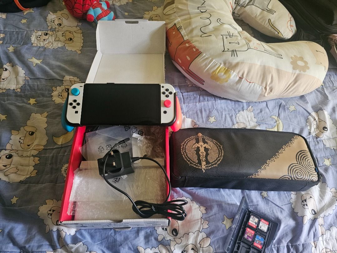 Nintendo Switch OLED Console Bundle with Games and Case (Category: Nintendo) located in Caloocan City. Submitted by chawnn (Listing ID 1465645767, Image 2). Description: - Nintendo Switch OLED Model (White & Black) in fully functional condition - Screen is clean and Joy-Cons work perfectly - Includes original box, power adapter, and a protective carrying case - Physical games included: God Eater 3, Assassin's Creed: The Rebel Collection, Pokémon 
