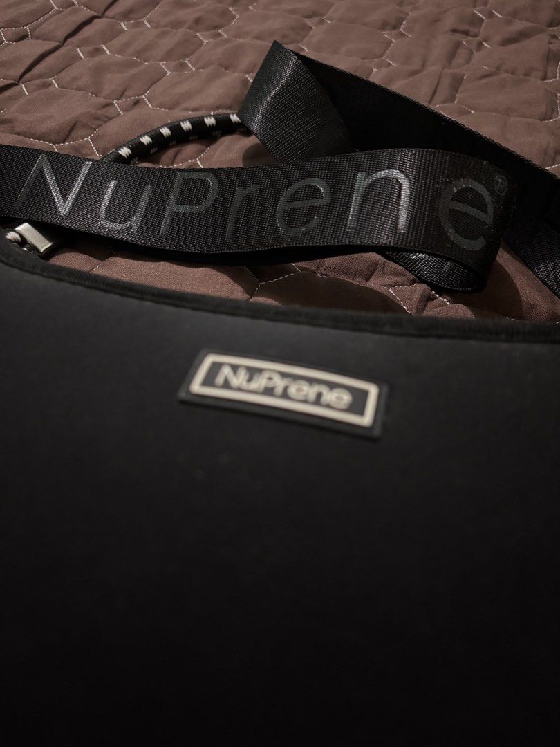 NuPrene Black Shoulder Bag with Branded Strap (Category: Shoulder Bags) located in Binan City. Submitted by fashion_claims (Listing ID 1465750817, Image 3). Description: - Brand: NuPrene - Color: Classic black - Material: Durable and lightweight neoprene - Strap: Thick, adjustable strap with bold NuPrene branding - Hardware: Silver-tone clips on both sides - Closure: Secure top zipper - Details: Front rectangular brand logo patch and clean black 