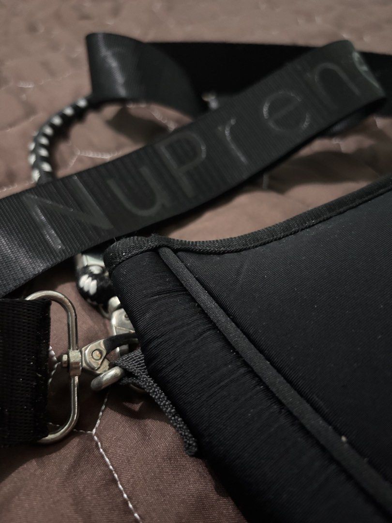 NuPrene Black Shoulder Bag with Branded Strap (Category: Shoulder Bags) located in Binan City. Submitted by fashion_claims (Listing ID 1465750817, Image 2). Description: - Brand: NuPrene - Color: Classic black - Material: Durable and lightweight neoprene - Strap: Thick, adjustable strap with bold NuPrene branding - Hardware: Silver-tone clips on both sides - Closure: Secure top zipper - Details: Front rectangular brand logo patch and clean black 