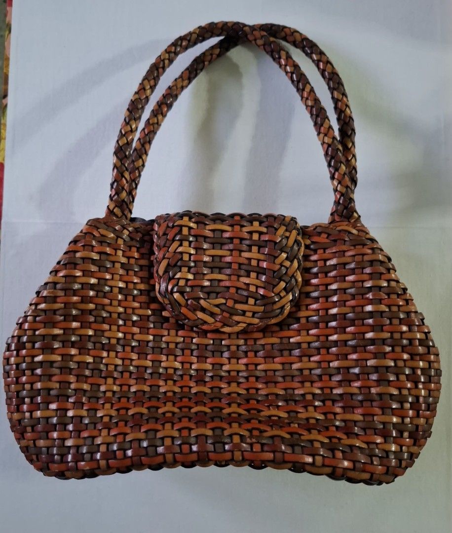 OFFEL du Paris Woven Leather Handbag Brown Multi (Category: Luxury Bags & Wallets) located in Don Carlos. Submitted by PphiXi_Finds (Listing ID 1465726887, Image 1). Description: Multicolor woven leather handbag from Offel du Paris. Shades of brown, tan, and orange throughout the body and braided shoulder straps. Flap closure with magnetic snap. Inside has colorful striped fabric lining, zipper pocket, and key leash. Gold-tone hardware. Clean int