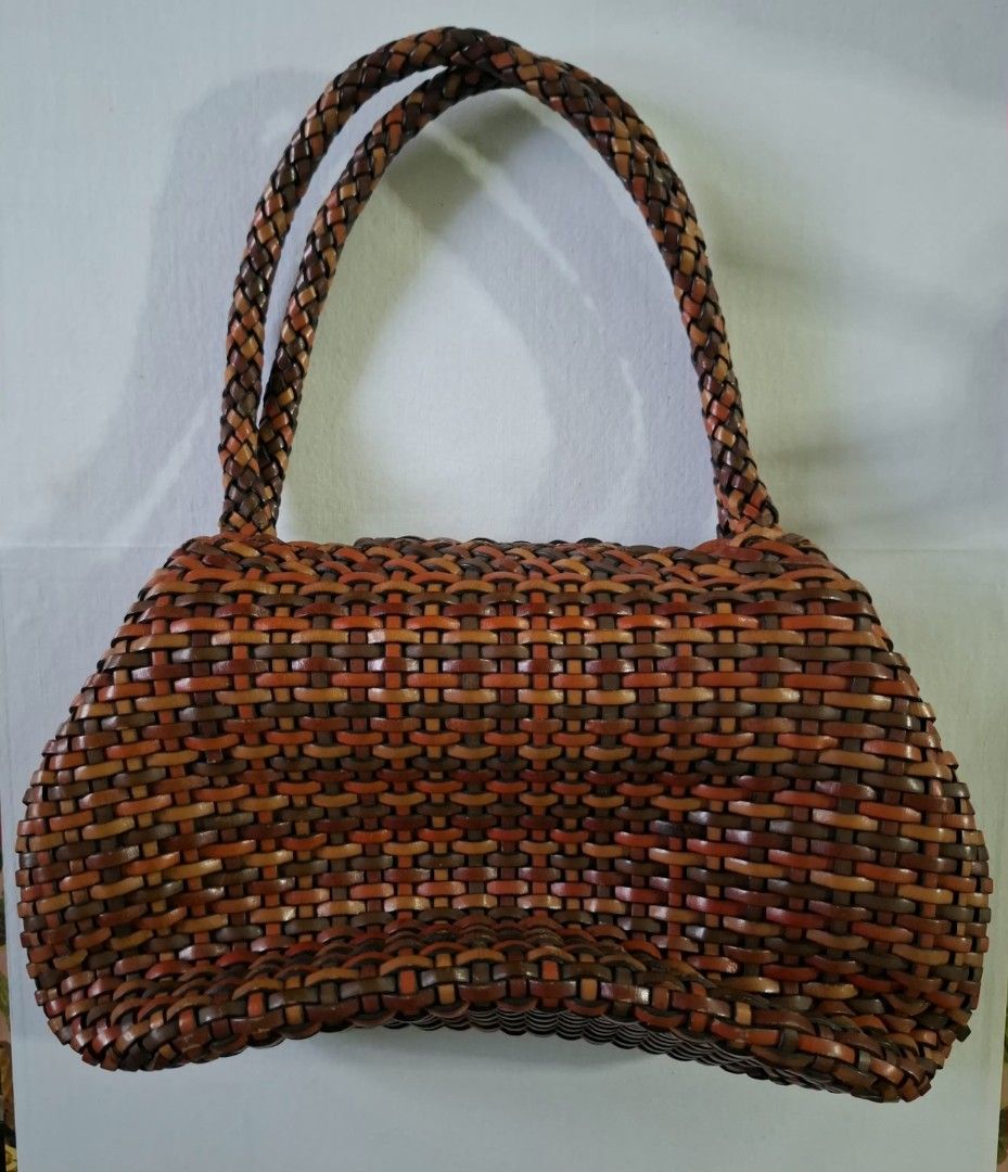 OFFEL du Paris Woven Leather Handbag Brown Multi (Category: Luxury Bags & Wallets) located in Don Carlos. Submitted by PphiXi_Finds (Listing ID 1465726887, Image 2). Description: Multicolor woven leather handbag from Offel du Paris. Shades of brown, tan, and orange throughout the body and braided shoulder straps. Flap closure with magnetic snap. Inside has colorful striped fabric lining, zipper pocket, and key leash. Gold-tone hardware. Clean int