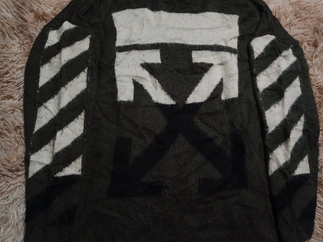 Off-White c/o Virgil Abloh Green Knit Sweater (Category: Coats, Jackets and Outerwear) located in Boston. Submitted by johnpaulvi30029 (Listing ID 1465692631, Image 3). Description: - Brand: Off-White c/o Virgil Abloh - Color: Dark green with signature white graphics - Design: Large back arrow graphic and diagonal sleeve stripes - Details: Classic ribbed collar, cuffs, and hem with 2013 copyright neck label - Fit & Material: Relaxed fit, thick kn