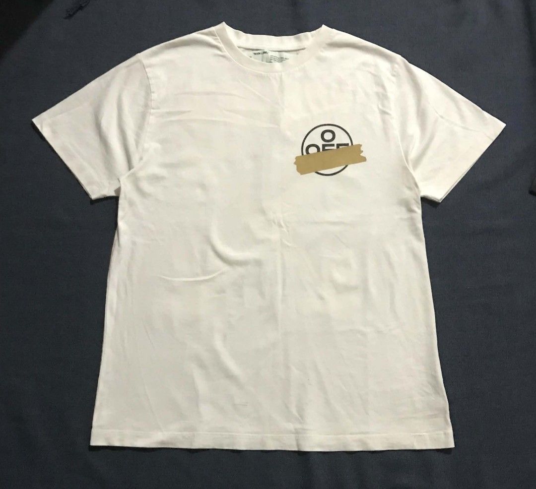 Off-White Tape Arrows White Tee (Category: Shirts) located in Manila. Submitted by its_d4ve (Listing ID 1465687360, Image 1). Description: White short sleeve tee from Off-White c/o Virgil Abloh. Iconic tape arrows graphic printed on the back and circular logo hit on the chest. "MAIN LABEL" neck tag with 2013 copyright info and standard wash care tag included. Soft cotton fabric, relaxed streetwear fit..