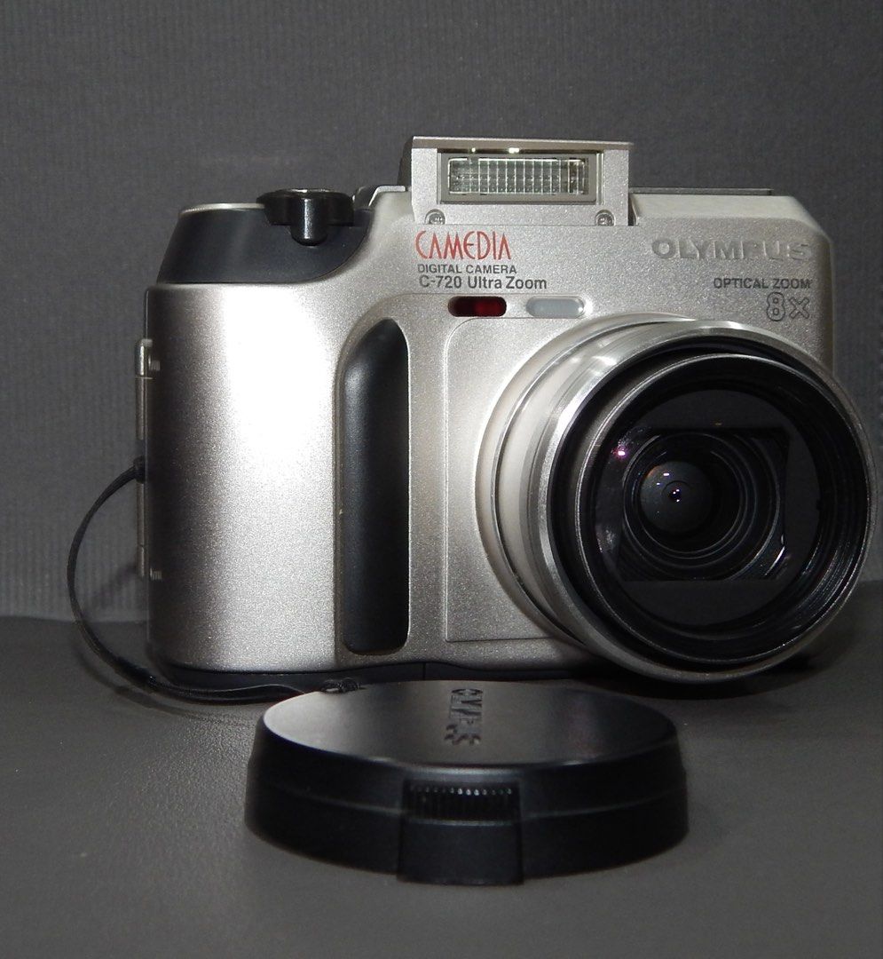 Olympus Camedia C-720 Ultra Zoom Digital Camera (Category: Cameras) located in Manila. Submitted by rexierex (Listing ID 1465688433, Image 2). Description: Olympus Camedia C-720 Ultra Zoom Digital Camera (Silver) Optics: 8x optical zoom lens with original attached lens cap - Flash: Built-in pop-up flash - Design: Compact body with a comfortable textured front grip - Convenience: Uses standard batteries and memory cards - Perfect for vintage digic