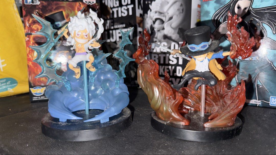 One Piece Luffy Gear 5 and Sabo Figures (Category: Figurines & Statues) located in Quezon City. Submitted by 1or3nz_ (Listing ID 1465644641, Image 2). Description: - Set of 2 One Piece anime figures on black circular bases - Monkey D. Luffy in Gear 5 form featuring a blue swirl effect and lightning bolts - Sabo surrounded by translucent orange flames while holding his iconic pipe - Highly detailed sculpts with dynamic, action-packed poses - Great