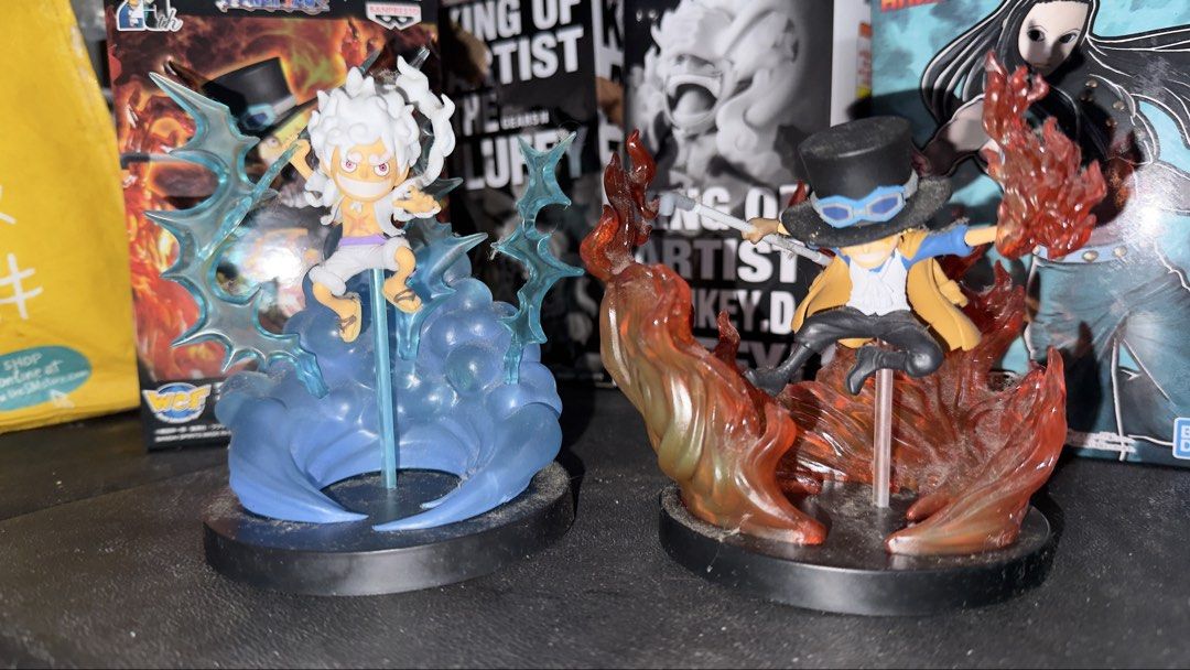 One Piece Luffy Gear 5 and Sabo Figures (Category: Figurines & Statues) located in Quezon City. Submitted by 1or3nz_ (Listing ID 1465644641, Image 3). Description: - Set of 2 One Piece anime figures on black circular bases - Monkey D. Luffy in Gear 5 form featuring a blue swirl effect and lightning bolts - Sabo surrounded by translucent orange flames while holding his iconic pipe - Highly detailed sculpts with dynamic, action-packed poses - Great
