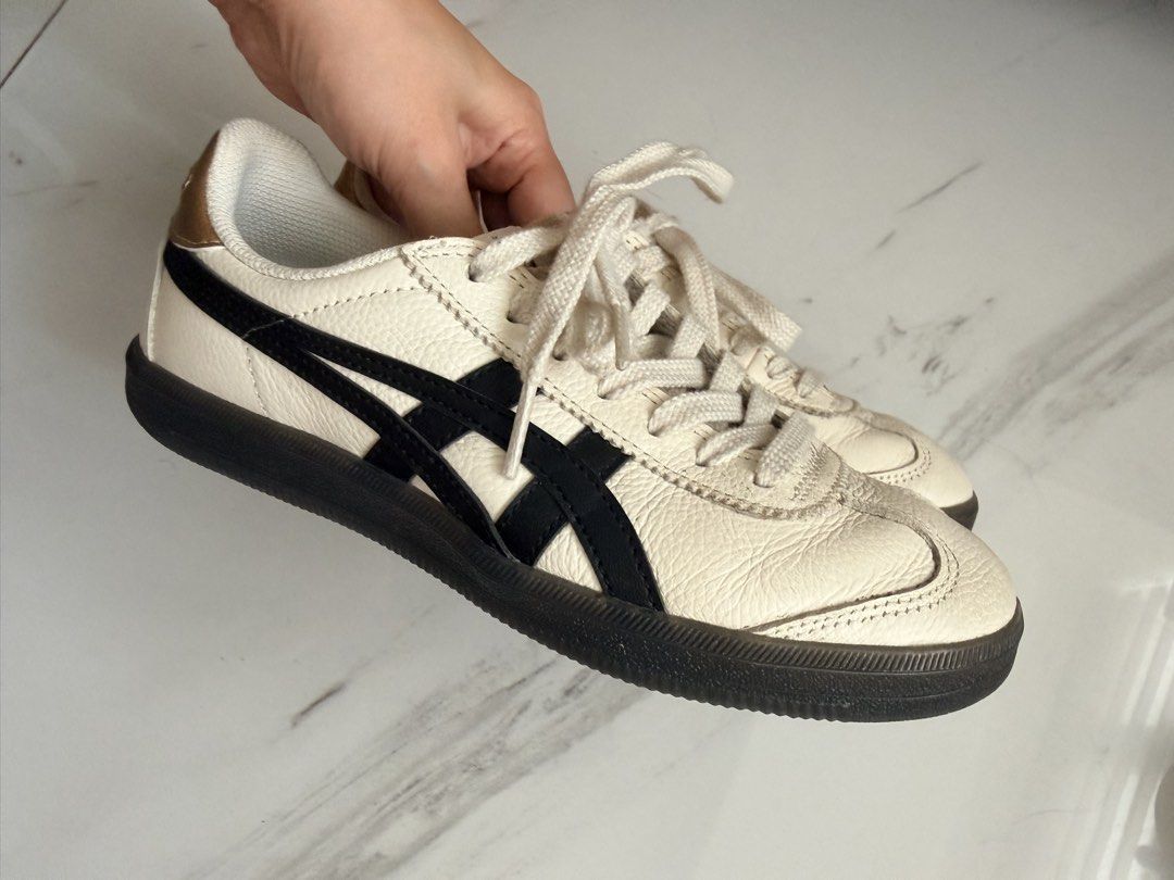 Onitsuka Tiger Tokuten Sneakers (Category: Sneakers) located in Quezon City. Submitted by hjane26 (Listing ID 1465636476, Image 3). Description: - Color/Material: White leather with black side stripes and metallic gold heel tab - Style: Classic low-top sneakers with flat white laces and black rubber soles - Details: Branded insoles - Condition: Gently worn, light creasing on toe boxes - RFS: Decluttering closet, grab it before it's gone! - Size: 