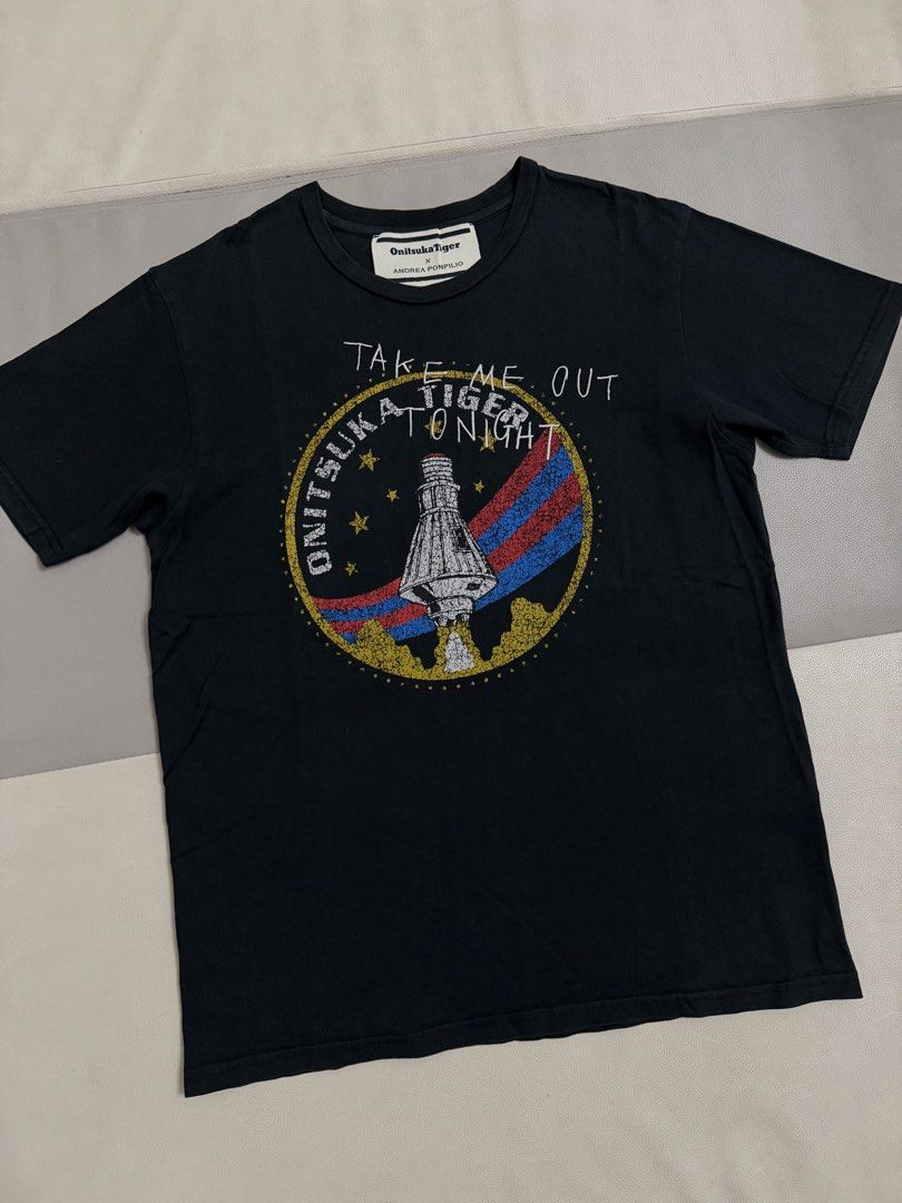 Onitsuka Tiger T-Shirt (Category: Tshirts & Polo Shirts ) located in Quezon City. Submitted by vaniefiel (Listing ID 1465747016, Image 2). Description: - Brand: Onitsuka Tiger x Andrea Pompilio - Item: Graphic Tee - Color: Black with space capsule graphic and 'Take Me Out Tonight' lettering - Size: L on tag - Check the pictures for actual size dimensions - Material: 100% cotton Location: Batasan Hills, QC Message me for more details! Thanks.