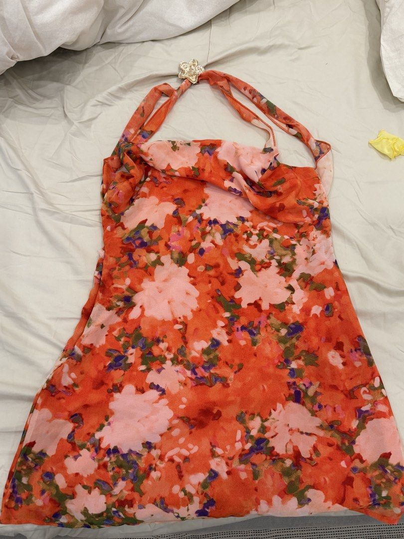 Orange Floral Halter Dress Open Back (Category: Dresses) located in Calamba. Submitted by miss.ksnap (Listing ID 1465645562, Image 2). Description: - Style: Halter midi dress with cowl neckline and open back - Design: Vibrant orange with an all-over pink floral pattern - Material: Lightweight and breathable, easy to slip on - Condition: Excellent, worn only once for a dinner - Perfect for: Warm weather, resort wear, or a night out.