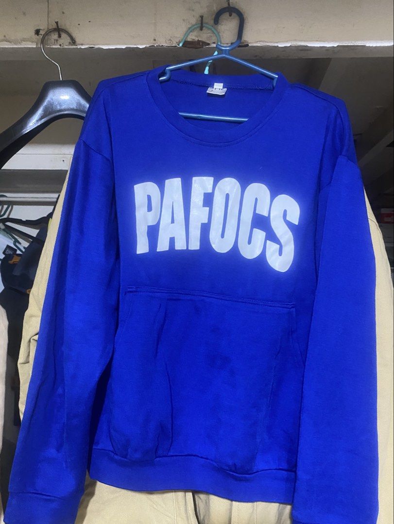 PAFOCS Blue Long Sleeve Sweatshirt with Front Pocket (Category: Coats, Jackets and Outerwear) located in Nagcarlan. Submitted by fiercewater-40fb (Listing ID 1465720230, Image 1). Description: - Color: Bright blue - Design: Large white PAFOCS text graphic on chest - Features: Built-in front pouch pocket near the bottom hem - Fit: Crew neck, standard long sleeves, ribbed cuffs and hem - Style: Comfortable everyday pullover.