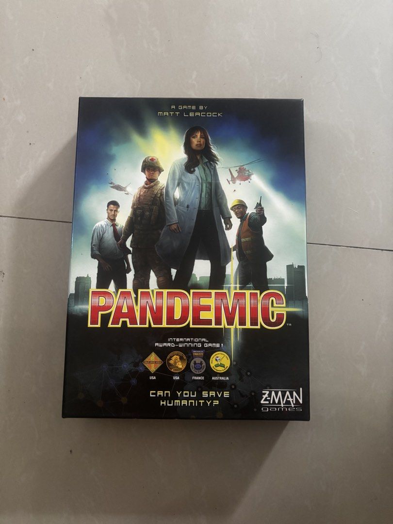 Pandemic Board Game Z-Man Games (Category: Board Games & Puzzles) located in Andop. Submitted by fammie_frayyss (Listing ID 1465621996, Image 1). Description: - Game: Pandemic (Cooperative board game by Matt Leacock) - Objective: Work together to save humanity from global diseases - Includes: Game board, rulebook, role cards, player cards, infection cards, pawns, disease cubes, and markers - Condition: All components neatly packed inside the orig