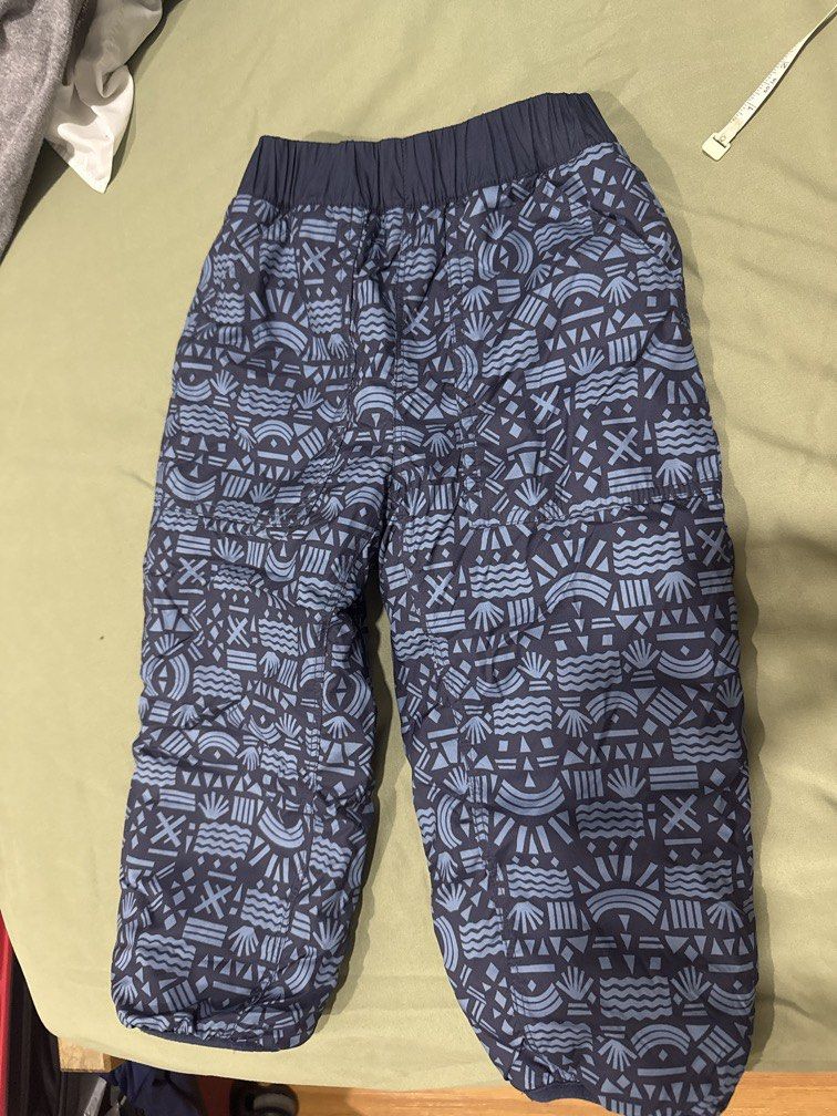 Patagonia Reversible Fleece and Printed Pants (Category: Babies & Kids Fashion) located in Manila. Submitted by .famousamos (Listing ID 1465692575, Image 3). Description: Patagonia pants, reversible design. One side has fuzzy navy blue fleece. Other side features a dark blue geometric pattern with abstract shapes. Elastic waistband and stretchy cuffs at the ankles. Includes a small pocket on the back with a snap button closure and Patagonia logo 
