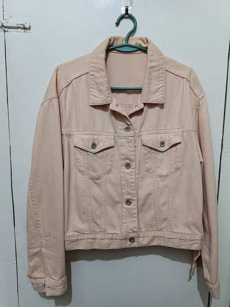 Uniqlo Peach pink denim jacket button up outerwear (Category: Coats, Jackets and Outerwear) located in Quezon City. Submitted by closeta38 (Listing ID 1465583364, Image 1). Description: - Peach pink denim jacket with a solid pastel tone - Button-up front with matching metal buttons - Two chest pockets with flaps and convenient side welt pockets - Long sleeves with adjustable buttoned cuffs - Structured collar and classic fit - Perfect layering pi