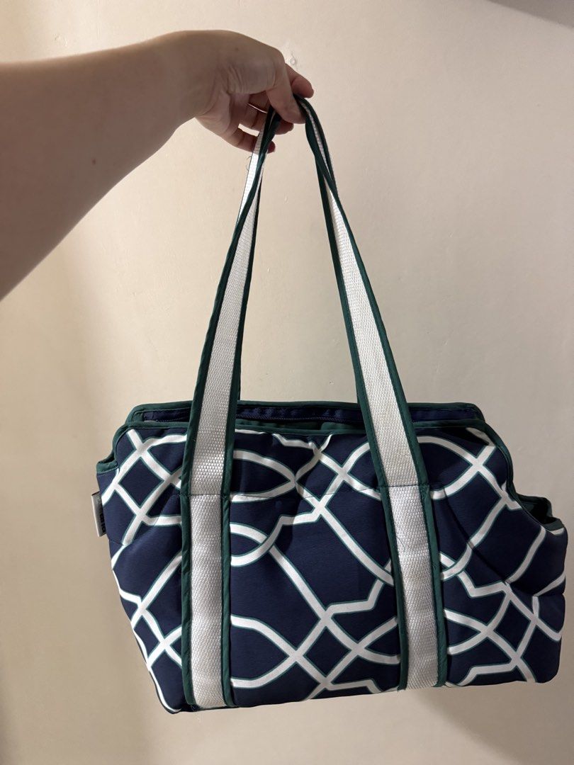 Pet Carrier Bag Navy Blue Geometric Pattern (Category: Homes & Other Pet Accessories) located in Quezon City. Submitted by jiaaa03_ (Listing ID 1465719202, Image 1). Description: - Color/Design: Navy blue with a chic white geometric lattice pattern - Interior: Cozy dark green quilted lining with a handy side pocket - Comfort: Includes a soft padded base for your pet - Straps: Sturdy white and green shoulder straps for easy carrying - Closure: Sec
