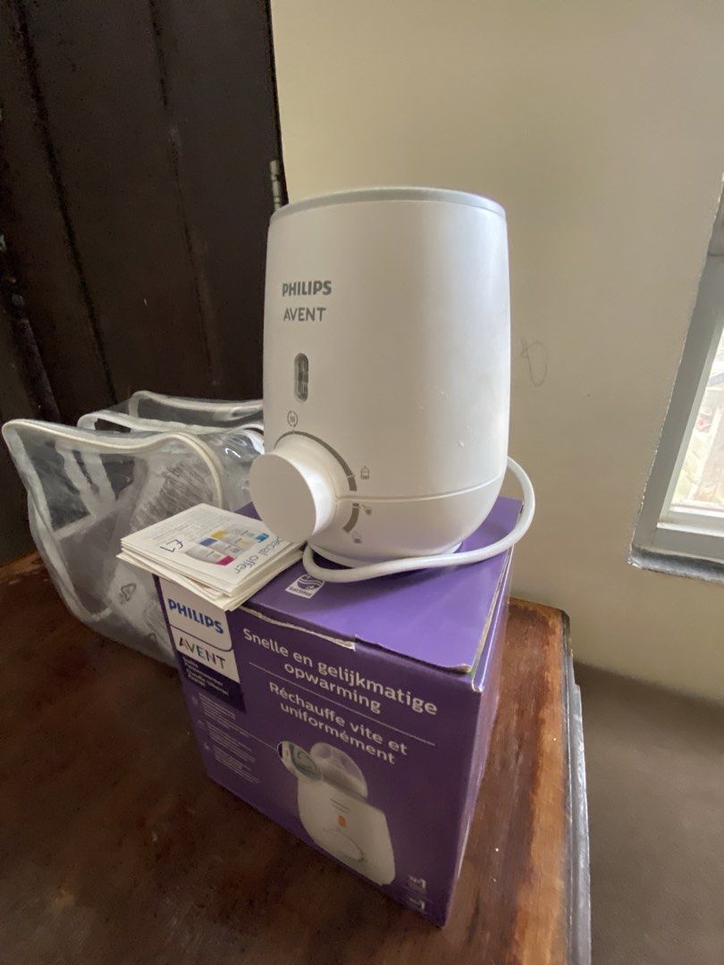 Philips Avent Fast Bottle Warmer (Category: Breastfeeding & Bottle Feeding) located in Manila. Submitted by king_1989 (Listing ID 1465590083, Image 3). Description: - Philips Avent bottle warmer in white - Heats milk and baby food quickly and evenly in about 3 minutes without hot spots - Simple dial control for easy temperature adjustment - Includes original purple box, transparent storage bag, and user manuals - Essential and reliable appliance 