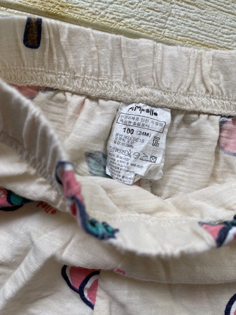 Pimpollo baby peach-print shorts (Category: Babies & Kids Fashion) located in Cebu City. Submitted by yjainani (Listing ID 1465590317, Image 3). Description: featuring a light cream or off-white base covered in a playful pattern of pink peaches with dark teal leaves.