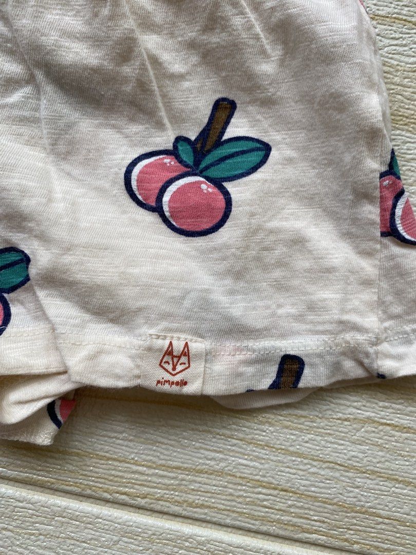 Pimpollo baby peach-print shorts (Category: Babies & Kids Fashion) located in Cebu City. Submitted by yjainani (Listing ID 1465590317, Image 2). Description: featuring a light cream or off-white base covered in a playful pattern of pink peaches with dark teal leaves.