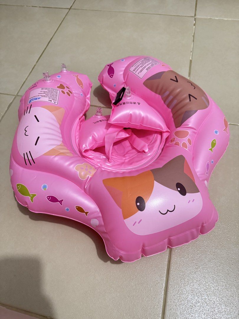 Pink Cute Cat Print Baby Swim Float Ring (Category: Babies & Kids Fashion) located in Pasay City. Submitted by decluttering_mom_2026 (Listing ID 1465674856, Image 1). Description: - Adorable pink design with cute cat graphics and colorful fish prints - Safe and secure with reliable safety buckles, adjustable straps, and multiple air chambers - Comfortable seat design to keep babies and toddlers fully supported - Lightweight and easily deflated fo