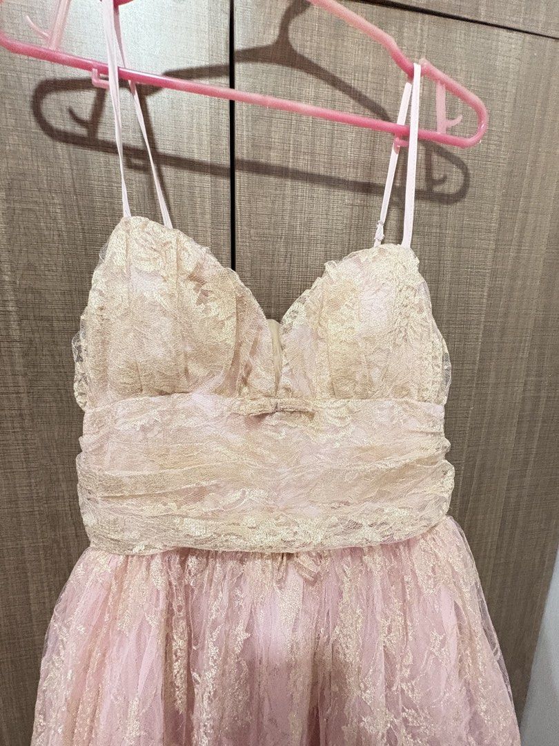 Pink Gold Lace Dress (Category: Dresses) located in Quezon City. Submitted by darshopxd (Listing ID 1465747711, Image 2). Description: - Pink midi dress with stunning metallic gold lace overlay - Sweetheart neckline with gathered bodice detailing - Adjustable spaghetti straps for a custom fit - Flared tulle skirt layer over a fully lined interior - Concealed back zipper closure for a seamless look - Soft and shimmery color combination, ideal for 