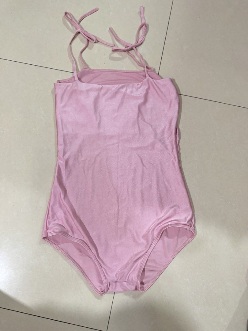 Pink One-Piece bodysuit with Tie Straps (Category: Bikinis & Swimsuits) located in Quezon City. Submitted by sweetlyluxe (Listing ID 1465619061, Image 2). Description: - Color/Finish: Shimmery pink - Design: Square neckline with high-cut leg opening - Straps: Adjustable tie straps at shoulders and upper back - Comfort: Fully lined interior - Ideal for: Beach vacations, pool parties, and tropical getaways.