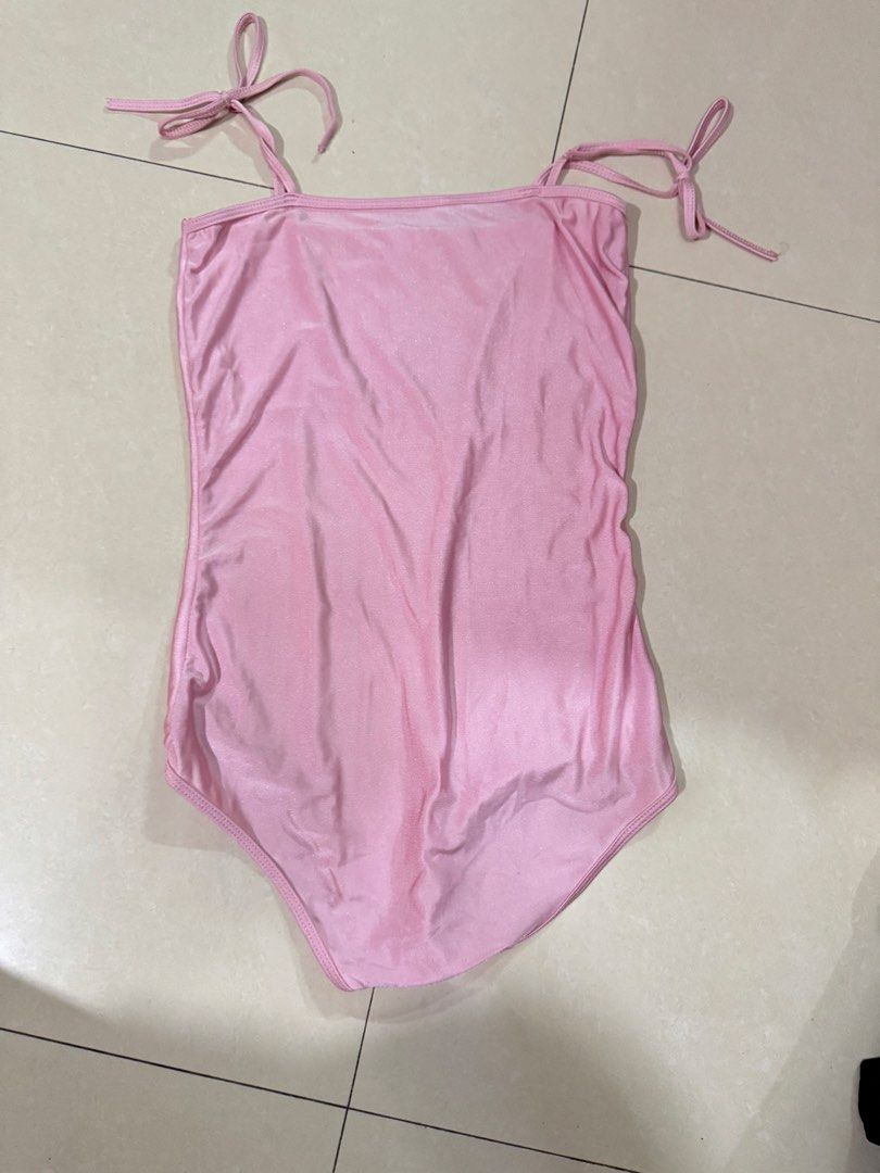 Pink One-Piece bodysuit with Tie Straps (Category: Bikinis & Swimsuits) located in Quezon City. Submitted by sweetlyluxe (Listing ID 1465619061, Image 1). Description: - Color/Finish: Shimmery pink - Design: Square neckline with high-cut leg opening - Straps: Adjustable tie straps at shoulders and upper back - Comfort: Fully lined interior - Ideal for: Beach vacations, pool parties, and tropical getaways.