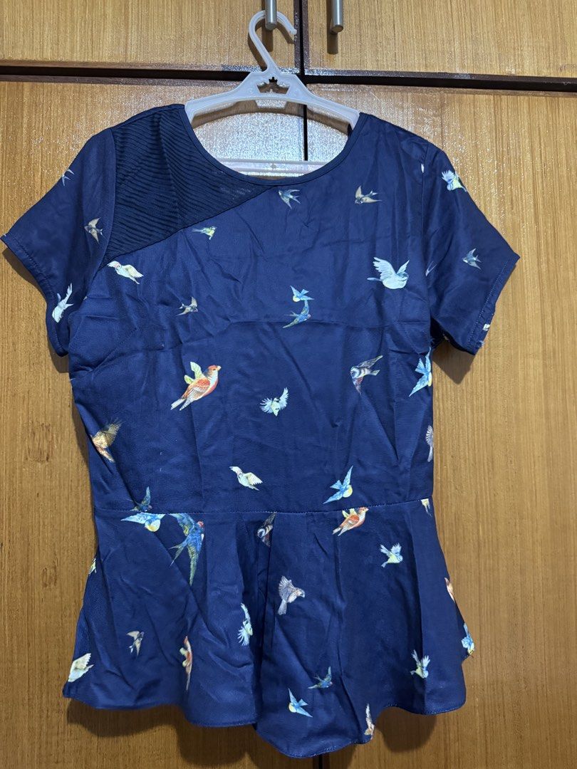 Plains & Prints Blue Bird Print Peplum Top (Category: Sleeveless) located in Santa Cruz, Pampanga. Submitted by eygee_rp (Listing ID 1465724397, Image 1). Description: - Brand: Plains & Prints - Color: Navy blue with colorful bird print - Size: PHL S, EUR 8, USA 4 - Design: Peplum style, short sleeves, unique pleated accent on the right shoulder - Back: V-neckline with hanging ties - Fabric: Lightweight and very comfortable.