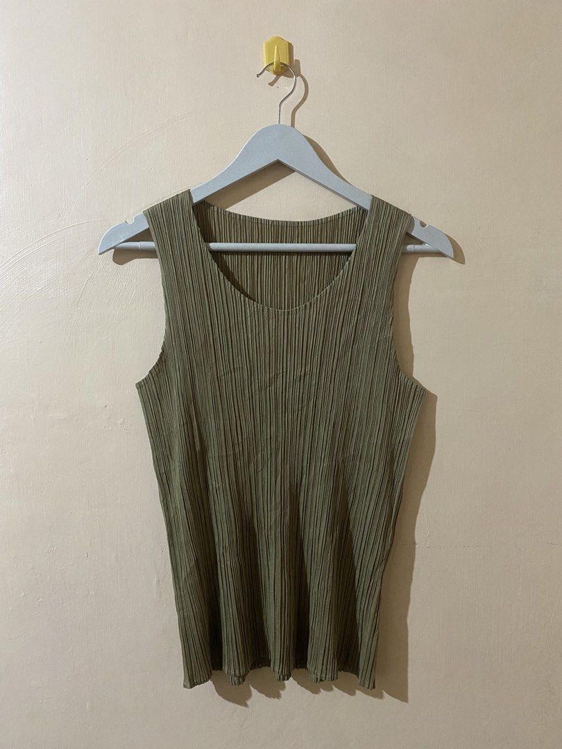 Pleats Please Issey Miyake sleeveless top (Category: Sleeveless) located in Naga. Submitted by trashfinds (Listing ID 1465593571, Image 1). Description: This garment is a pleated sleeveless top, iconic for its distinct finely crinkled texture known as plissé or garment-pleating.The color is a muted khaki or olive green, and the design is highly reminiscent of pieces from the signature Pleats Please Issey Miyake collection. This lightweight, stret