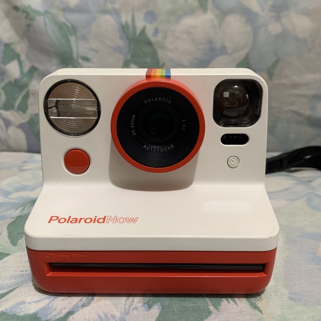 Polaroid Now Autofocus i-Type Instant Camera Red White (Category: Cameras) located in Manila. Submitted by coolstuffonlyyy (Listing ID 1465608316, Image 1). Description: - Model: Polaroid Now Instant Camera - Color: Red and White - Features: Autofocus lens, built-in flash, and USB rechargeable - Compatibility: Uses i-Type film - Condition: Tested and works great - Inclusions: Original box and charging cable - Perfect for: Parties, trips, and ever