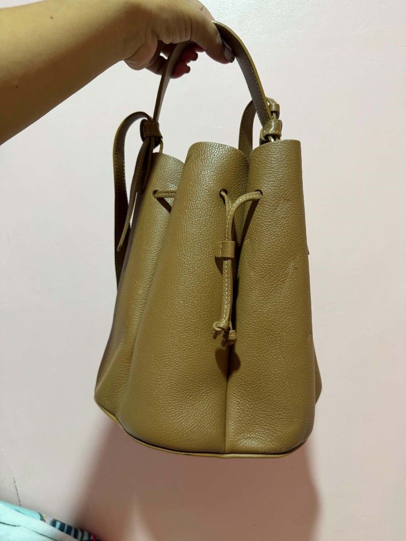 Polene numero huit camel bucket bag (Category: Luxury Bags & Wallets) located in Puerto Princesa. Submitted by lotsstuff (Listing ID 1465668274, Image 3). Description: The Numero Huit Mini is designed for the modern lifestyle, offering a versatile solution for daily essentials. Its dimensions, 19 x 18 x 18 cm, provide ample space for a large iPhone Pro Max, a portable charger, and other necessities, proving its practicality. While it can accommod
