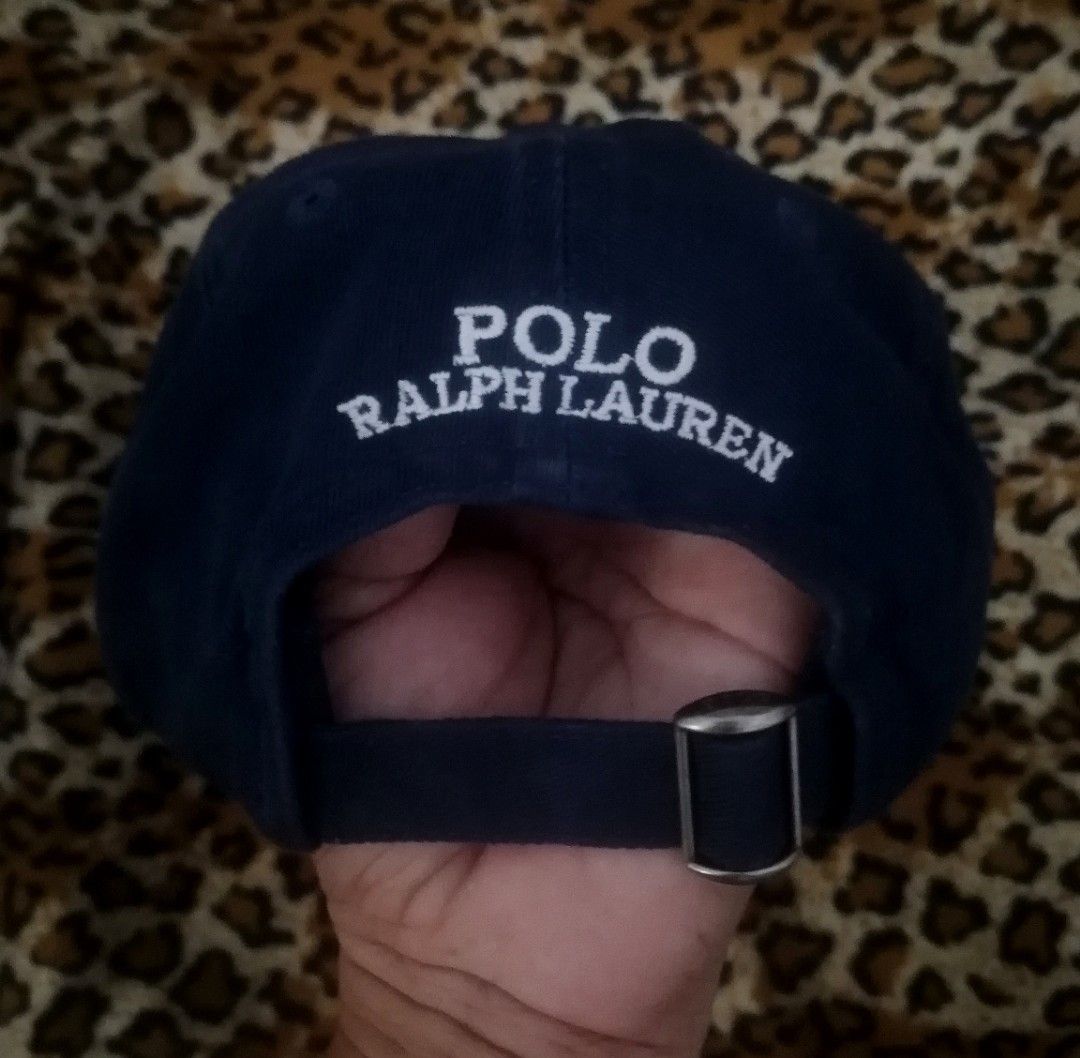 Polo Ralph Lauren Bear Navy Baseball Cap (Category: Caps & Hats) located in Cebu City. Submitted by roadthrift (Listing ID 1465702987, Image 2). Description: - Brand: Polo Ralph Lauren - Color: Navy Blue - Design: Iconic Polo Bear holding a football embroidered on front with 'POLO' lettering - Back Details: 'POLO RALPH LAUREN' embroidered across the strap area - Material: 100% cotton - Size: One size fits most (tagged 59cm), adjustable metal buck
