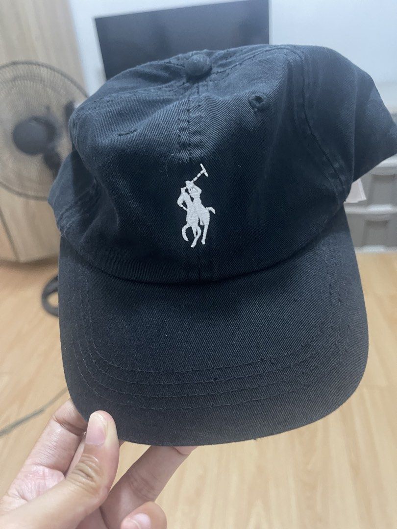 Polo Ralph Lauren Black Cap (Category: Caps & Hats) located in Manila. Submitted by jvlni (Listing ID 1465653226, Image 2). Description: - Brand: Polo Ralph Lauren - Color: Classic Black with White Embroidered Pony Logo - Material: 100% Cotton for comfortable everyday wear - Size: One size fits all, fully adjustable strapback with a metal buckle - Details: Features 'POLO' lettering embroidered on the back and original interior branding tags - Con