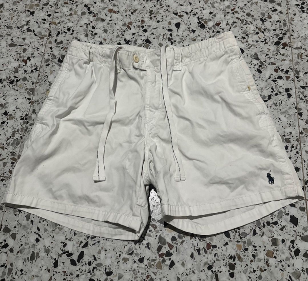 Polo Ralph Lauren White Shorts (Category: Shorts) located in Caloocan City. Submitted by ithrift2k24 (Listing ID 1465705742, Image 3). Description: - Brand: Polo Ralph Lauren - Size: Waist 36 Length 16 - Color: Classic White - Details: Iconic embroidered pony logo on hem - Waistband: Drawstring with button closure and zipper fly - Pockets: Includes back pocket with button closure - Style: Casual and comfortable for warm weather - Condition: Excel
