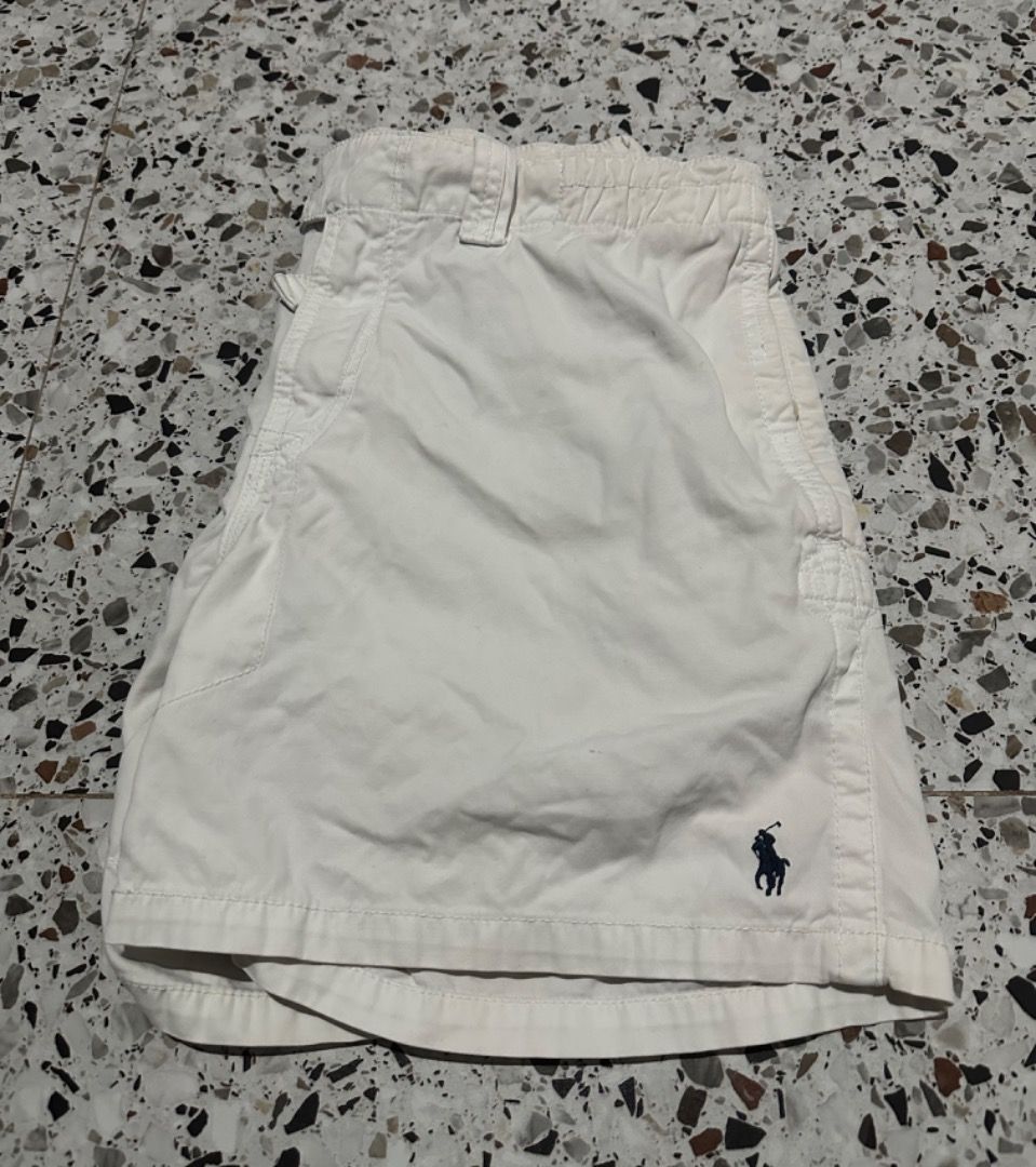 Polo Ralph Lauren White Shorts (Category: Shorts) located in Caloocan City. Submitted by ithrift2k24 (Listing ID 1465705742, Image 1). Description: - Brand: Polo Ralph Lauren - Size: Waist 36 Length 16 - Color: Classic White - Details: Iconic embroidered pony logo on hem - Waistband: Drawstring with button closure and zipper fly - Pockets: Includes back pocket with button closure - Style: Casual and comfortable for warm weather - Condition: Excel