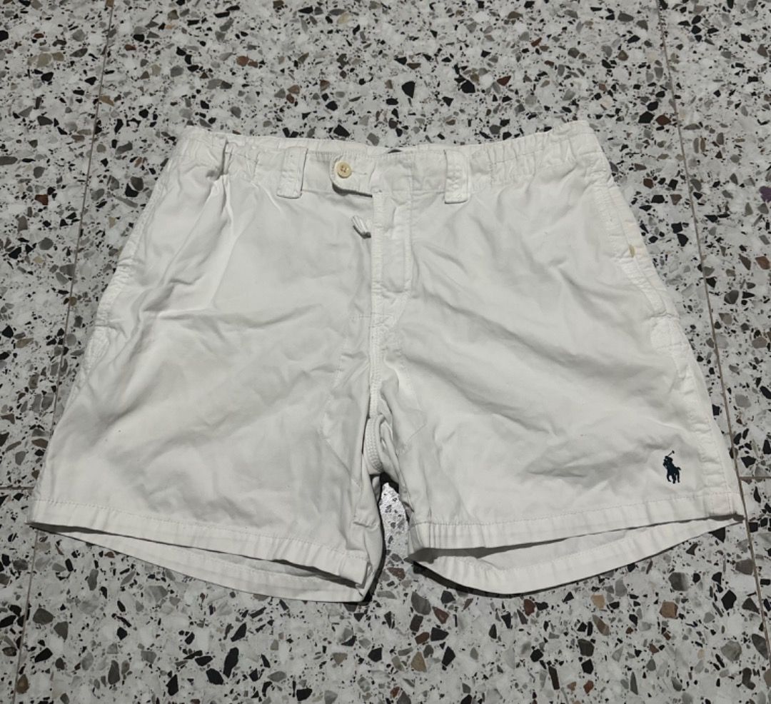 Polo Ralph Lauren White Shorts (Category: Shorts) located in Caloocan City. Submitted by ithrift2k24 (Listing ID 1465705742, Image 2). Description: - Brand: Polo Ralph Lauren - Size: Waist 36 Length 16 - Color: Classic White - Details: Iconic embroidered pony logo on hem - Waistband: Drawstring with button closure and zipper fly - Pockets: Includes back pocket with button closure - Style: Casual and comfortable for warm weather - Condition: Excel